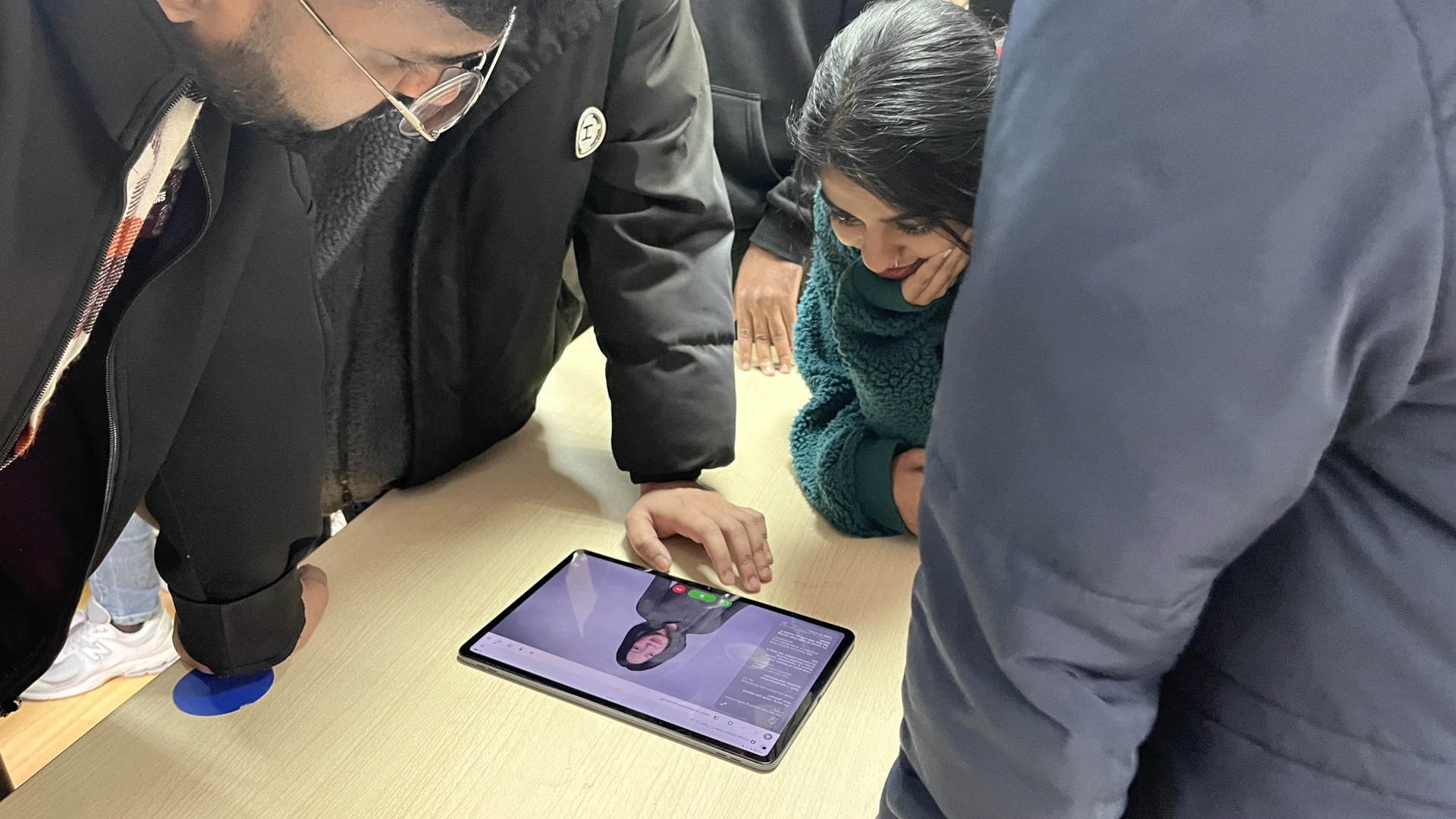 Students gathering around a tablet with a virtual patient